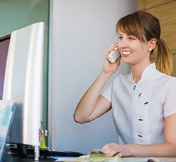 Dental receptionist on the phone